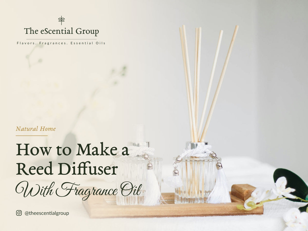 Two glass reed diffusers on a wooden tray with white orchids